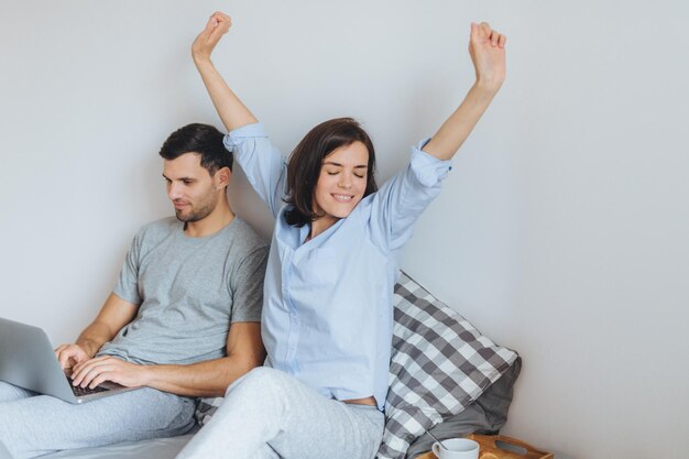 Couple relaxing on bed at home