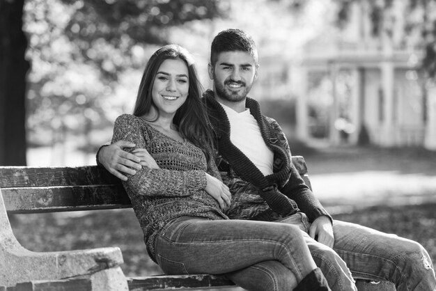 Couple Relaxing On Bench In Autumn Park