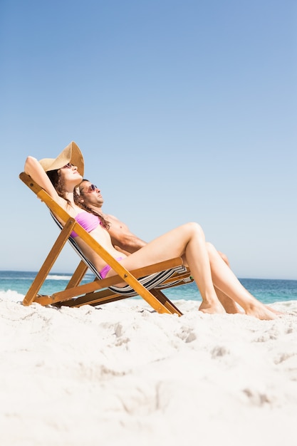 Couple relaxing on deck chair