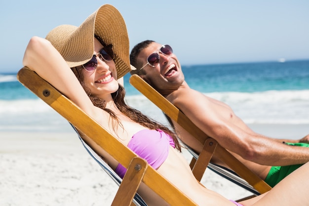 Couple relaxing on deck chair