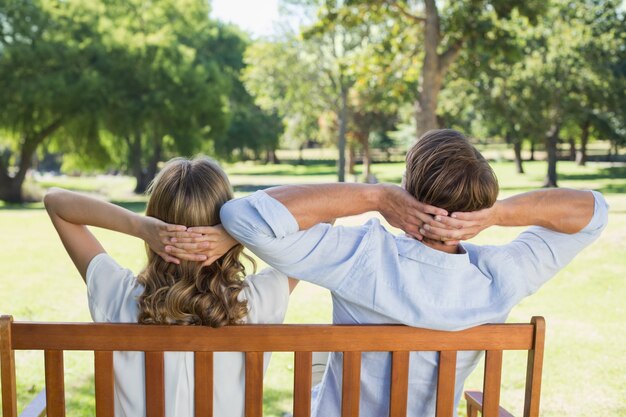 Couple relaxing on park bench together