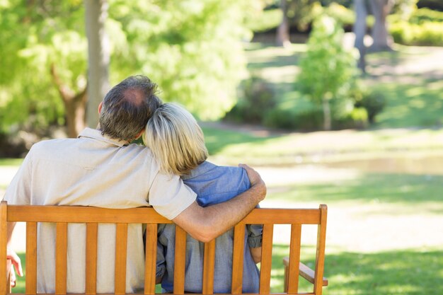 Couple relaxing on park bench