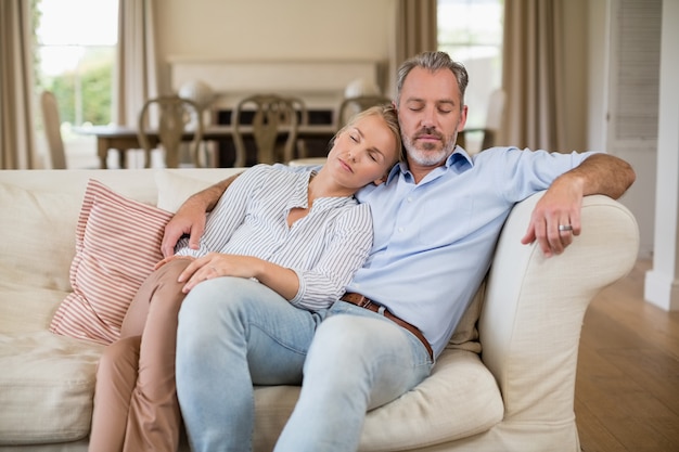 Couple relaxing on sofa in living room