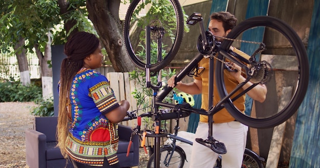 Couple repair bicycle with tools in yard