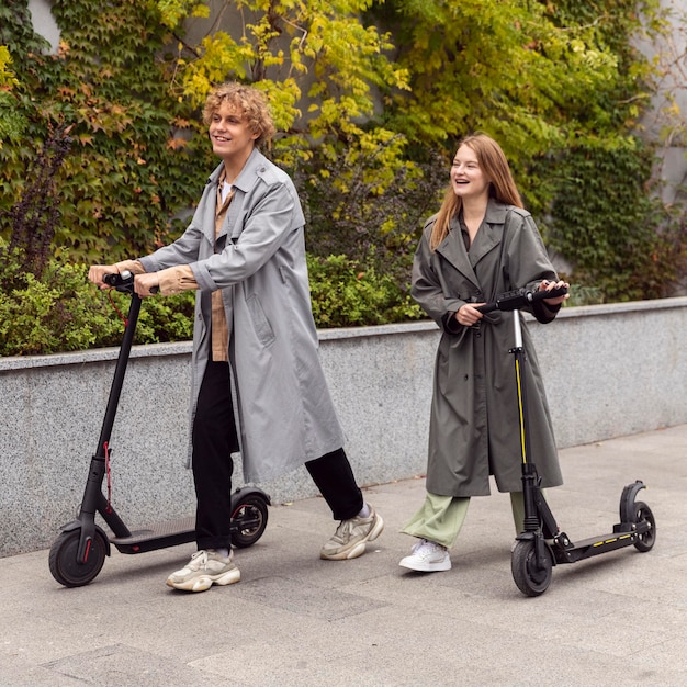 Photo couple riding electric scooters together