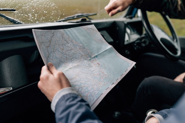 Photo couple on a road trip checking the map