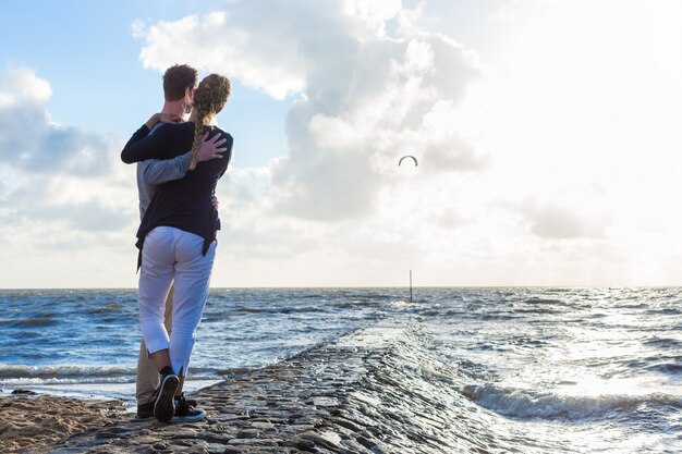 Couple in romantic sunset on ocean beach