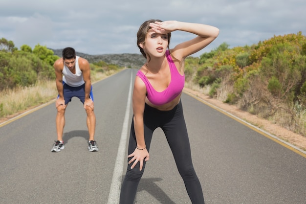 Couple running on the open road together