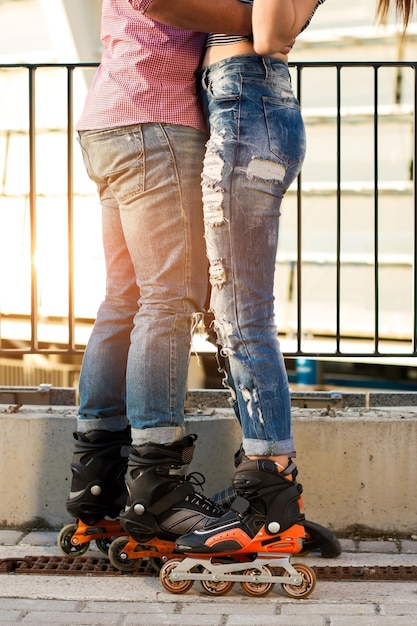 Couple's legs on inline skates.