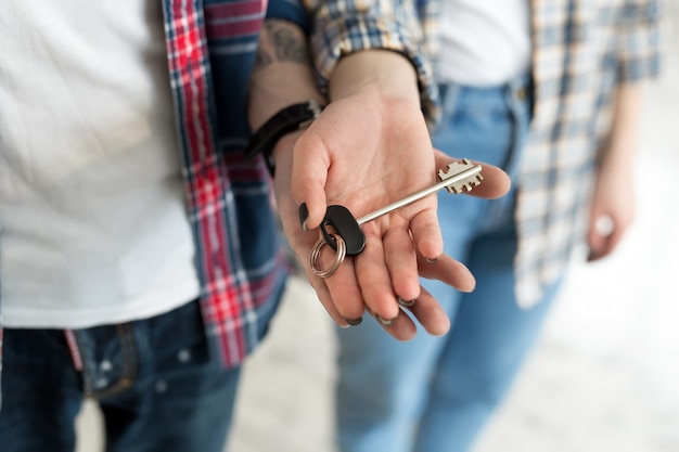 Couple showing key to new home