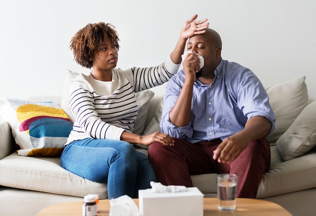 Couple sick at home on the sofa