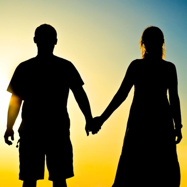 couple silhouette in front of a sunset