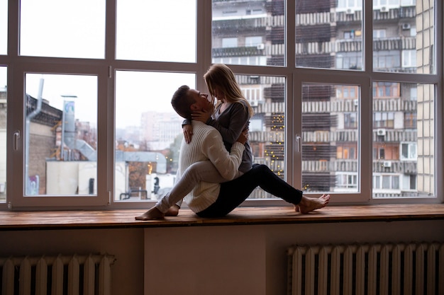 Couple sits near window in the room