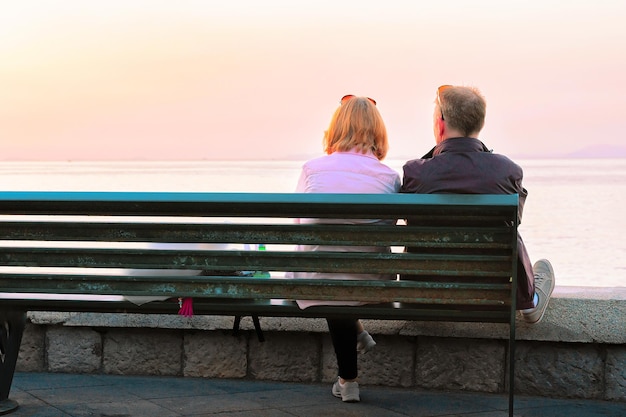 Couple sitting on the bench in Marina Grande in Sorrento, Tyrrhenian sea, Amalfi coast, Italy