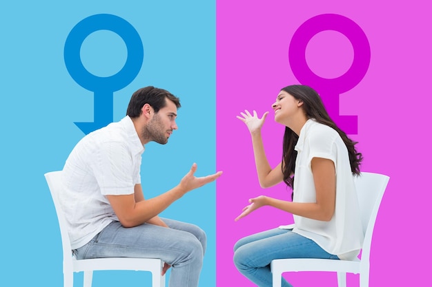 Couple sitting on chairs arguing against pink and blue