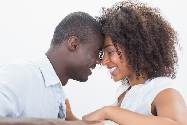 Couple sitting on couch together smiling 