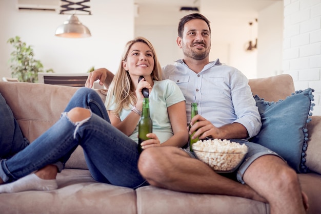 Couple sitting on couch and watching TV