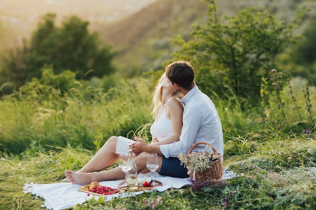 couple sitting on a date on a picnic in the park