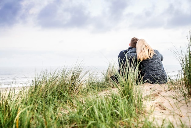 Couple sitting in dunes