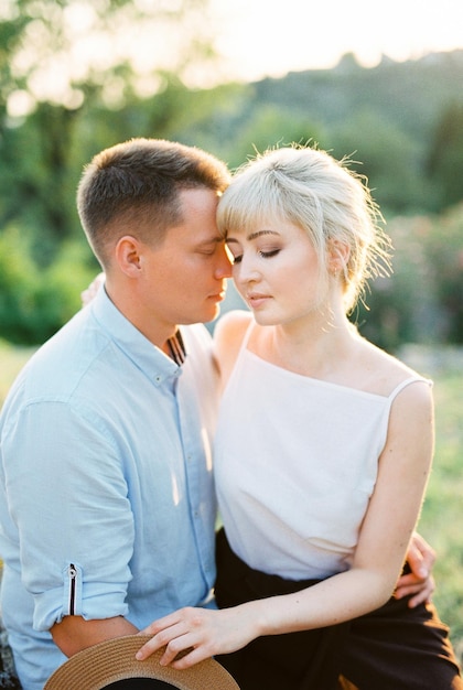 Couple sitting in an embrace in a green park