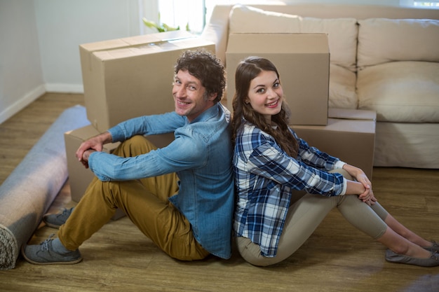 Couple sitting on the floor back to back