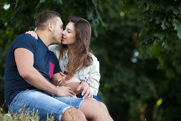 Couple sitting kissing