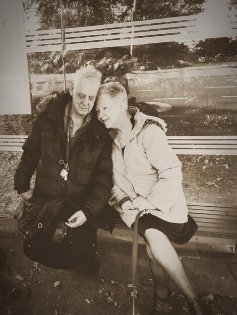 Couple sitting in park during winter