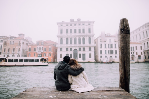 Couple sitting on pier