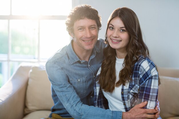 Couple sitting together on sofa