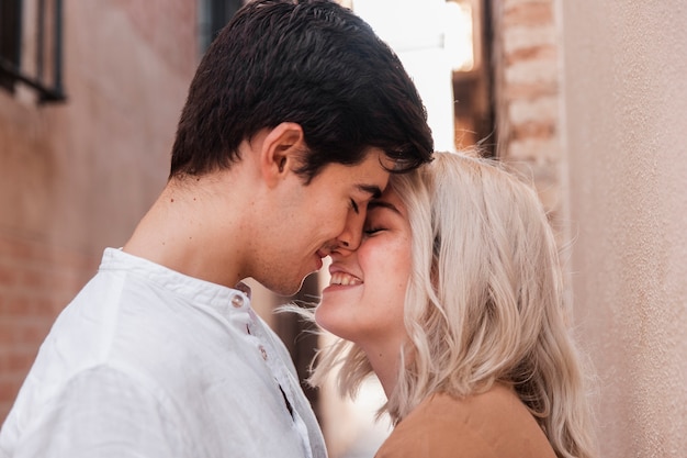 Couple smiling and going in for a kiss