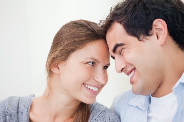 Couple smiling while touching forehead 