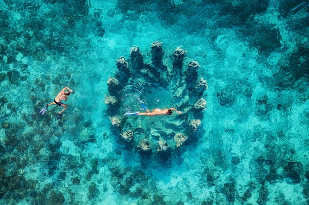 The couple snorkeling near the famous place on Gili Meno Island Indonesia Aerial view from drone Underwater tourism in the ocean Vacation and adventure Travel image