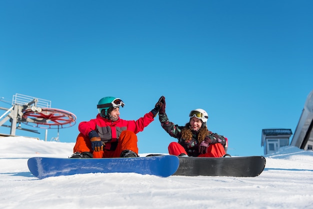 Couple of snowboarders in the mountain