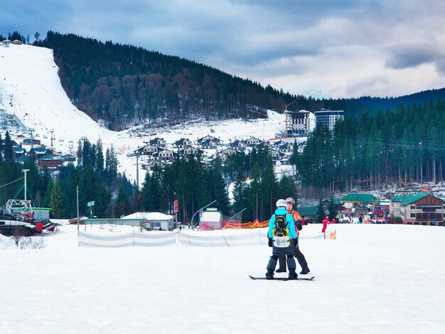 Couple snowboarding instructor teacher with student