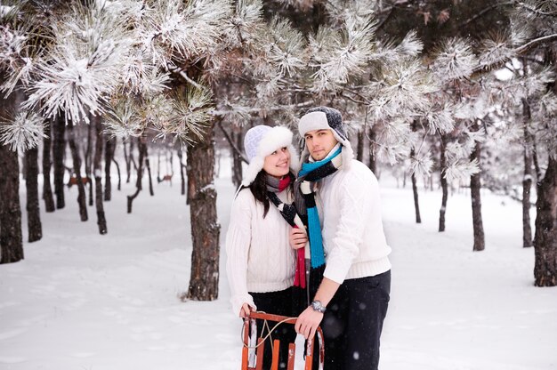 Couple on snowy tree forest