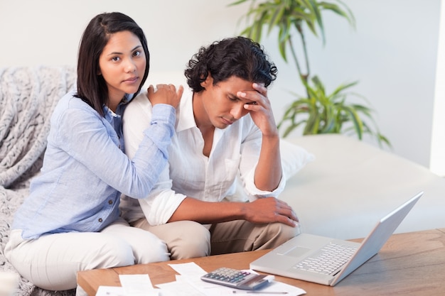 Couple on the sofa doing their calculations