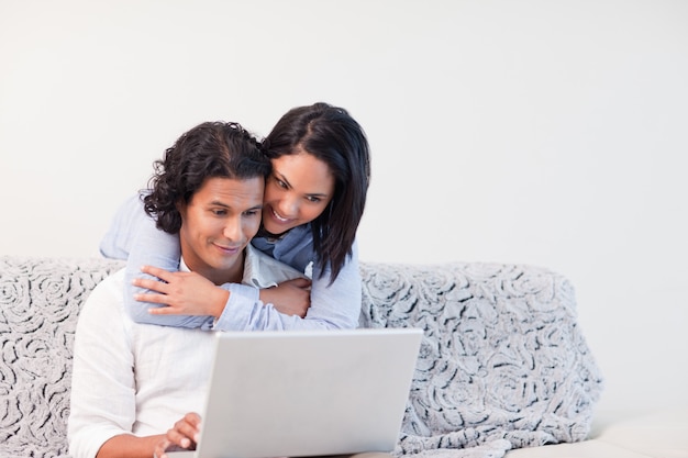 Couple spending time online in the living room together