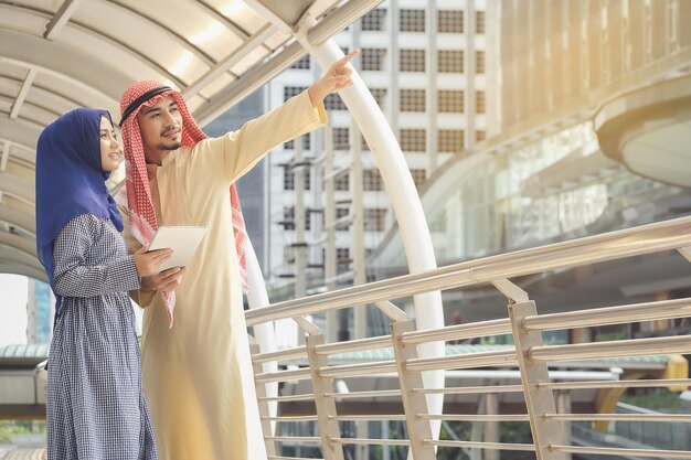 Couple standing on footbridge