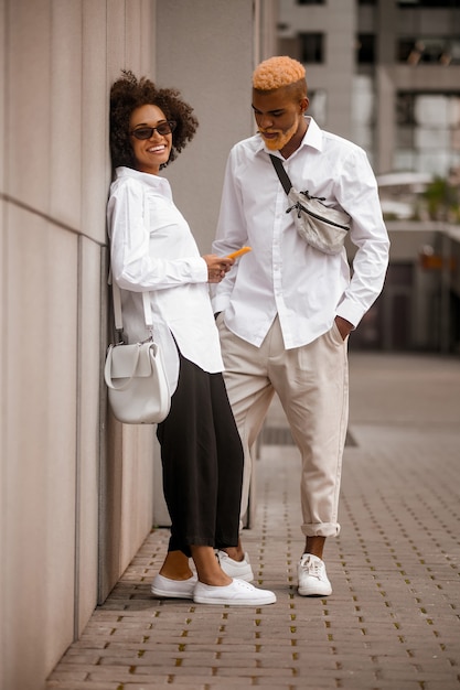 A couple standing near the wall and talking