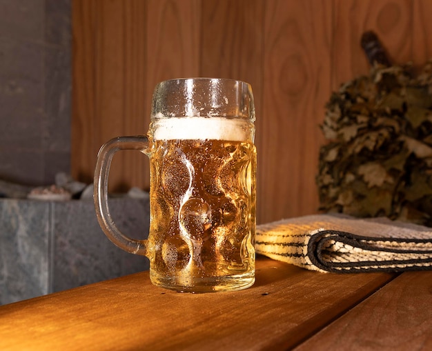 Couple of steamed mug of light fresh beer in the sauna on the shelf