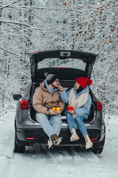 The couple stopped their car for lunch on the way through the forest