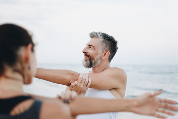 Couple stretching at the beach