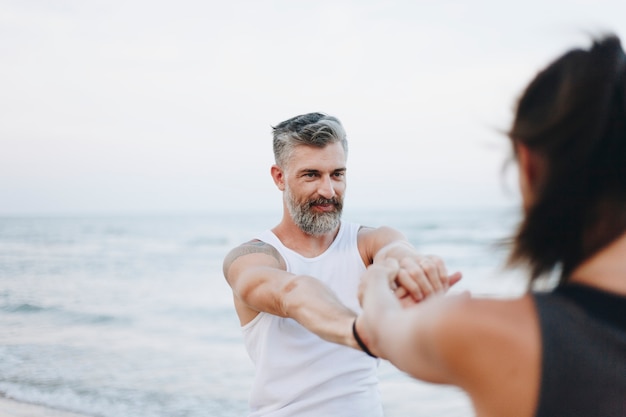 Couple stretching at the beach