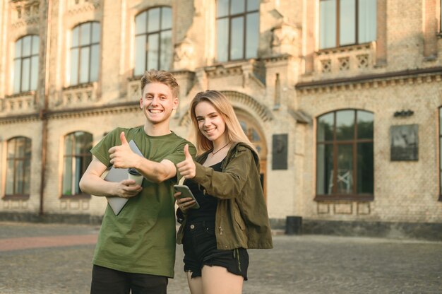 Couple of students standing near college