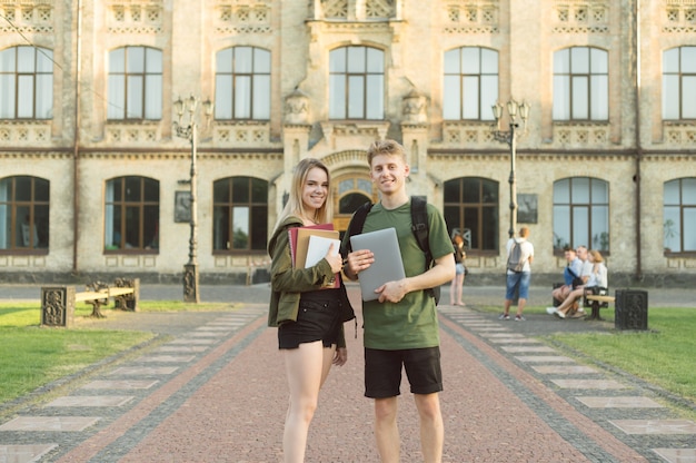 Couple of students standing near college