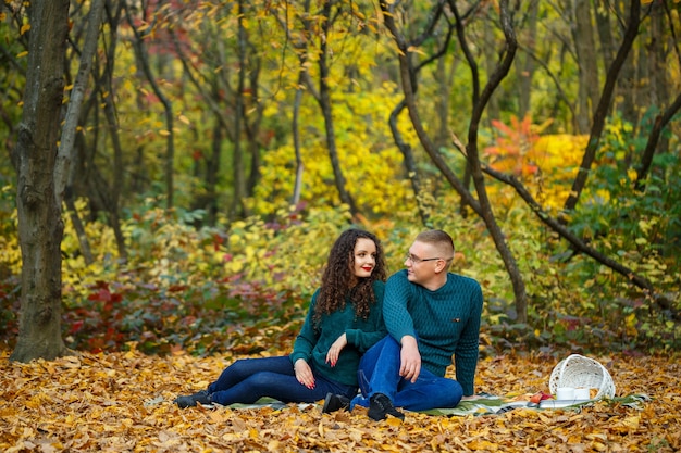 Couple in sweaters in the autumn park