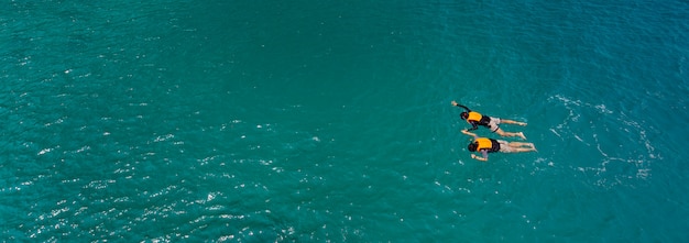 Couple swim in sea