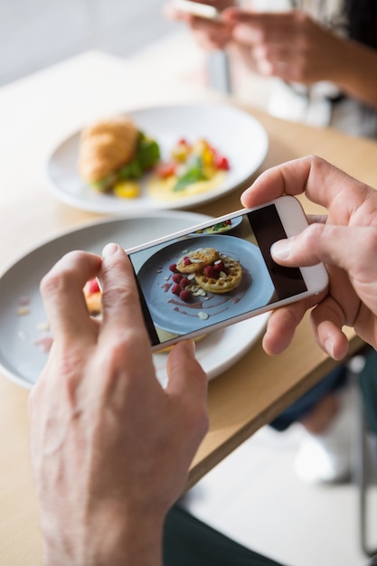 Couple taking a photo of their snacks