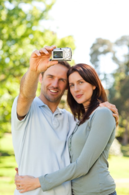 Couple taking a photo of themselves in the park