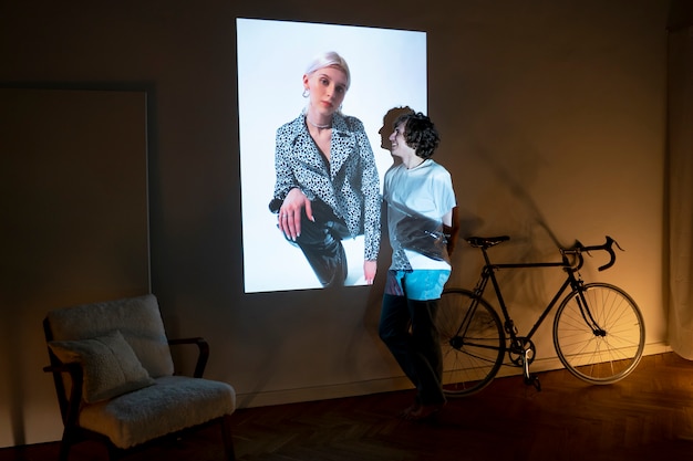 Couple taking photos in the light of movie projector